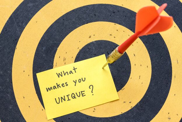 massage what makes you unique over dartboard background brand